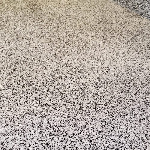 Professional epoxy flake installation in a Beaver Bank garage, providing a waterproof and easy-to-clean flooring solution.